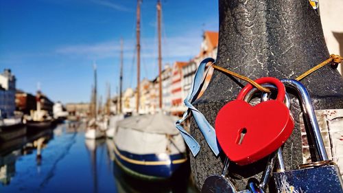 Close-up of love lock hanging on boat in canal