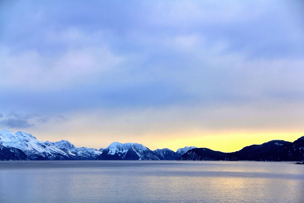 snow, winter, cold temperature, mountain, tranquil scene, mountain range, scenics, tranquility, season, beauty in nature, snowcapped mountain, sky, weather, water, waterfront, lake, nature, cloud - sky, frozen, idyllic