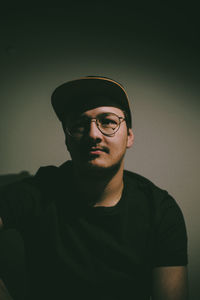 Portrait of man wearing hat against gray background