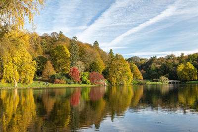 View of the autumn colours around the lake at stourhead gardens in wiltshire.