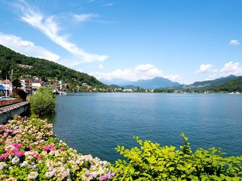 Scenic view of lake by mountains against sky