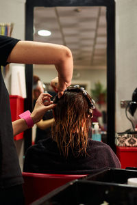 Close up shot of a hairdresser doing her client's curls