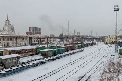 Snow-covered railway station krasnodar-1 with different types of cars on the track