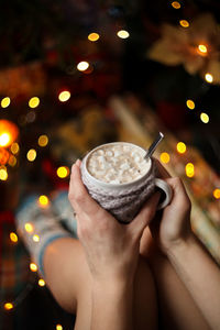 Midsection of person holding coffee cup