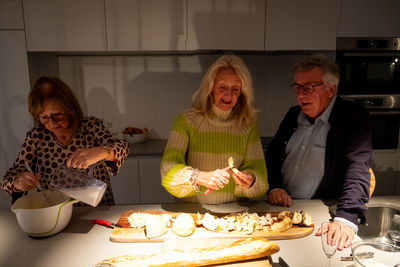 Portrait of smiling woman holding food at home