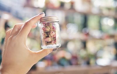 Close-up of woman holding glass jar