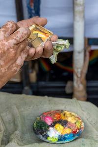 Cropped hand of person preparing food