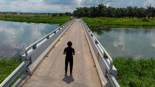 Rear view of man on lake