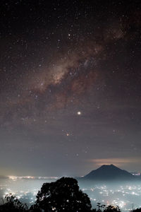 Low angle view of milkyway on bali over a lake 