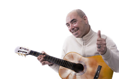 Portrait of man holding camera over white background