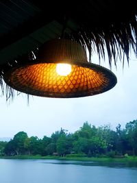 Low angle view of lantern hanging against sky