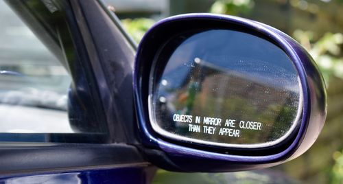 Close-up of side-view mirror of car