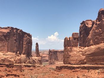 Rock formations on cliff against sky