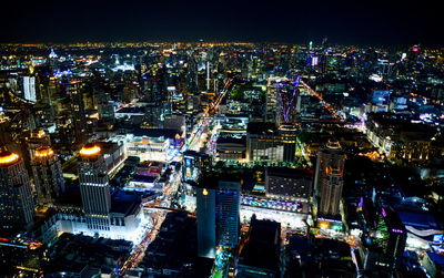 High angle view of city lit up at night