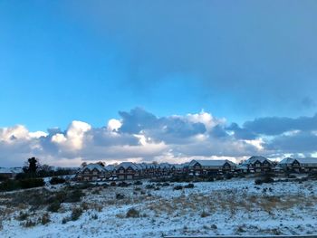 Scenic view of landscape against blue sky during winter