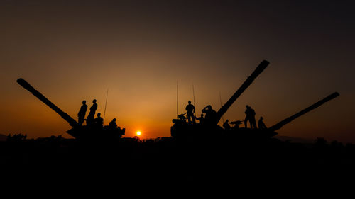 Silhouette people against clear sky during sunset