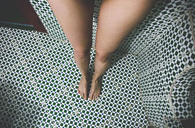 High angle view of woman legs in water