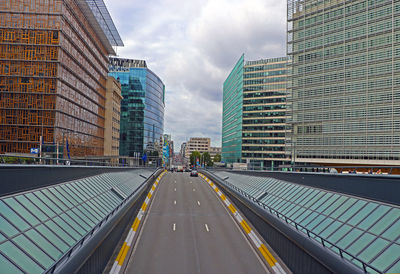 Street amidst buildings, in brussels, against sky