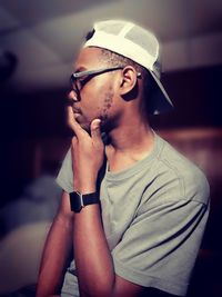 Portrait of young man wearing hat at home