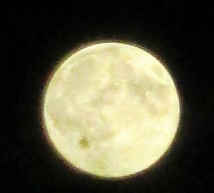 Low angle view of moon in the dark