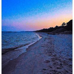 Scenic view of beach against sky during sunset