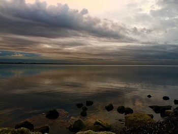 Scenic view of sea against cloudy sky