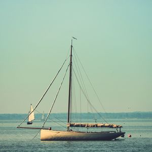 Ship sailing on sea against clear sky