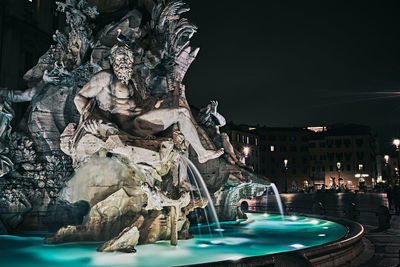 View of fountain in city at night