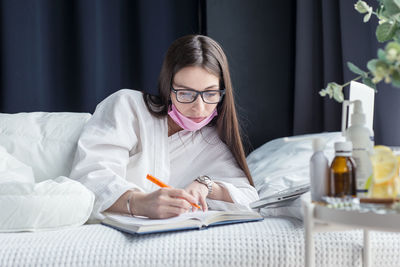 Young woman sitting on book