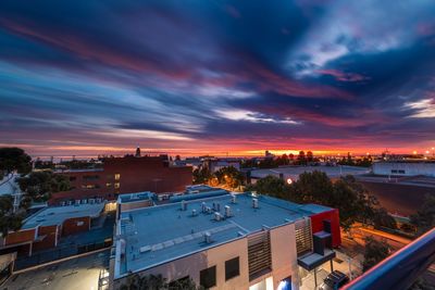 High angle view of illuminated buildings against sky at sunset