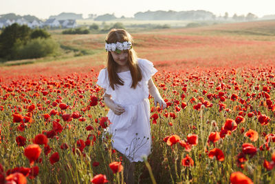 Girl on poppy meadow