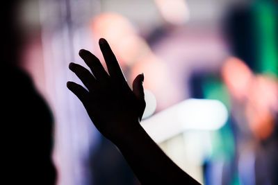 Close-up of silhouette hand against blurred background