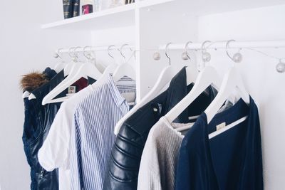 Jackets and t-shirts hanging on clothes rack