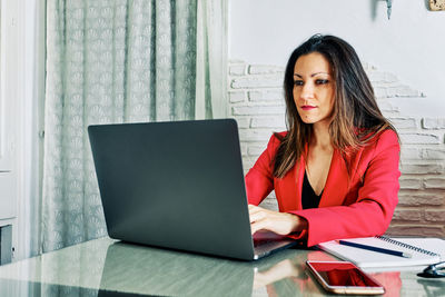 Portrait of a young woman using smart phone