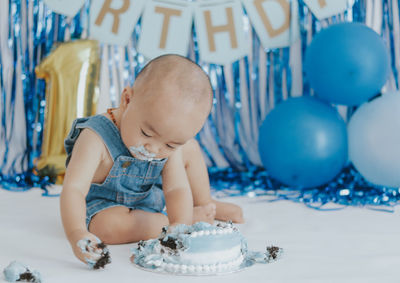 High angle view of boy playing with balloons