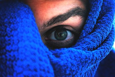 Close-up portrait of woman with blue towel