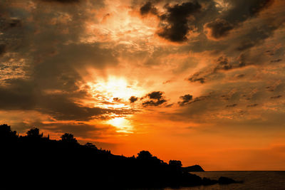 Scenic view of dramatic sky over sea during sunset