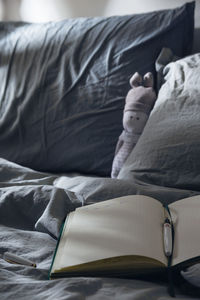 Midsection of person relaxing on bed at home