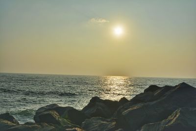 Scenic view of sea against sky at sunset