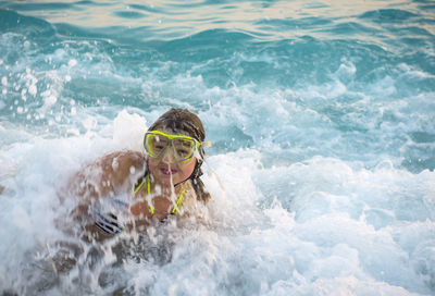 Portrait of girl swimming in sea at beach