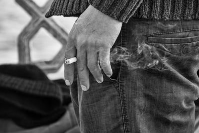 Close-up of man holding cigarette