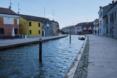 Canal amidst buildings in city