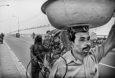 Man with basket on road in city