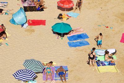 High angle view of people enjoying summer at beach