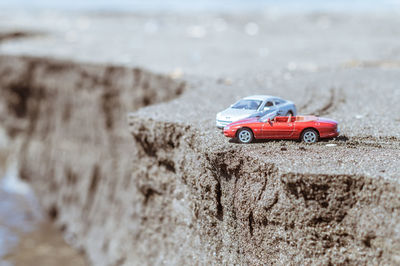 Close-up of toy car on beach