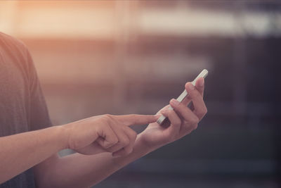 Midsection of woman using mobile phone