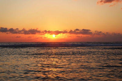 Scenic view of sea against romantic sky at sunset