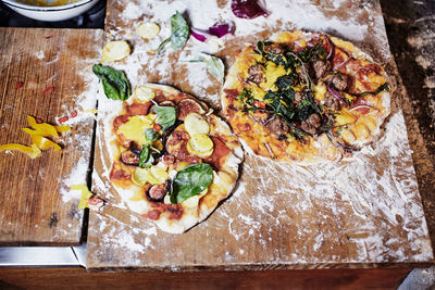 High angle view of pizza on cutting board