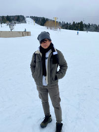 Full length of man standing on snow covered field