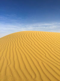 Scenic view of desert against blue sky